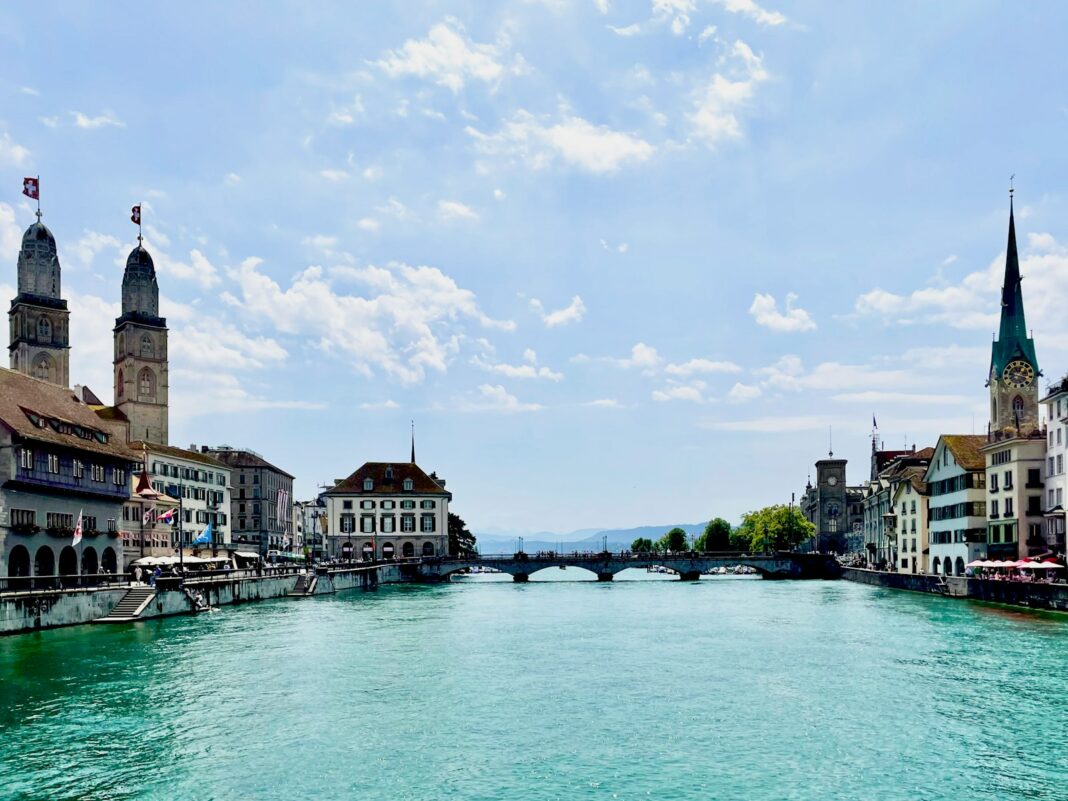 A river running through a city next to tall buildings