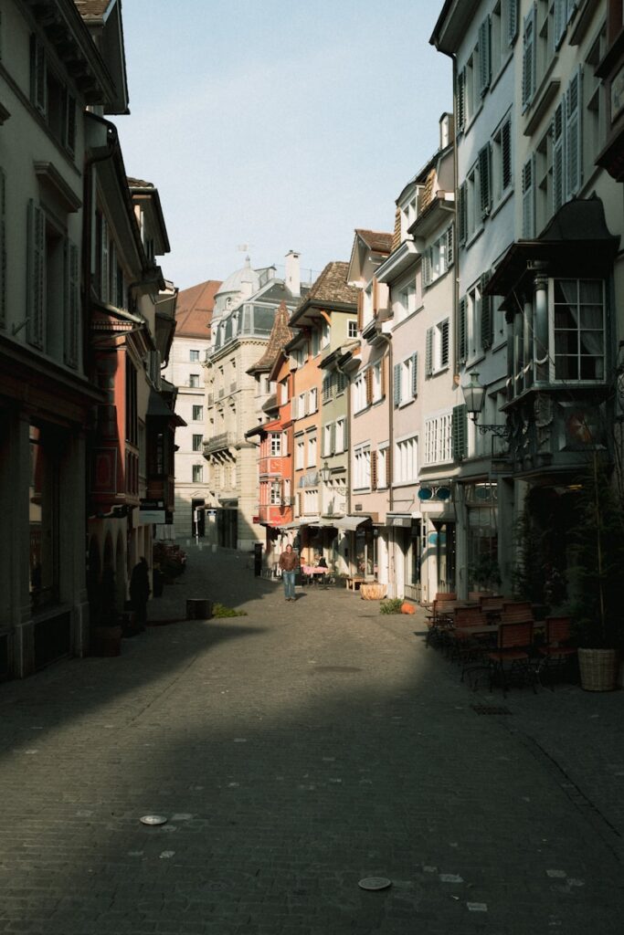 Zurich, switzerland: the chill, surprisingly fun city you probably don’t expect 1 A narrow street lined with colorful buildings.